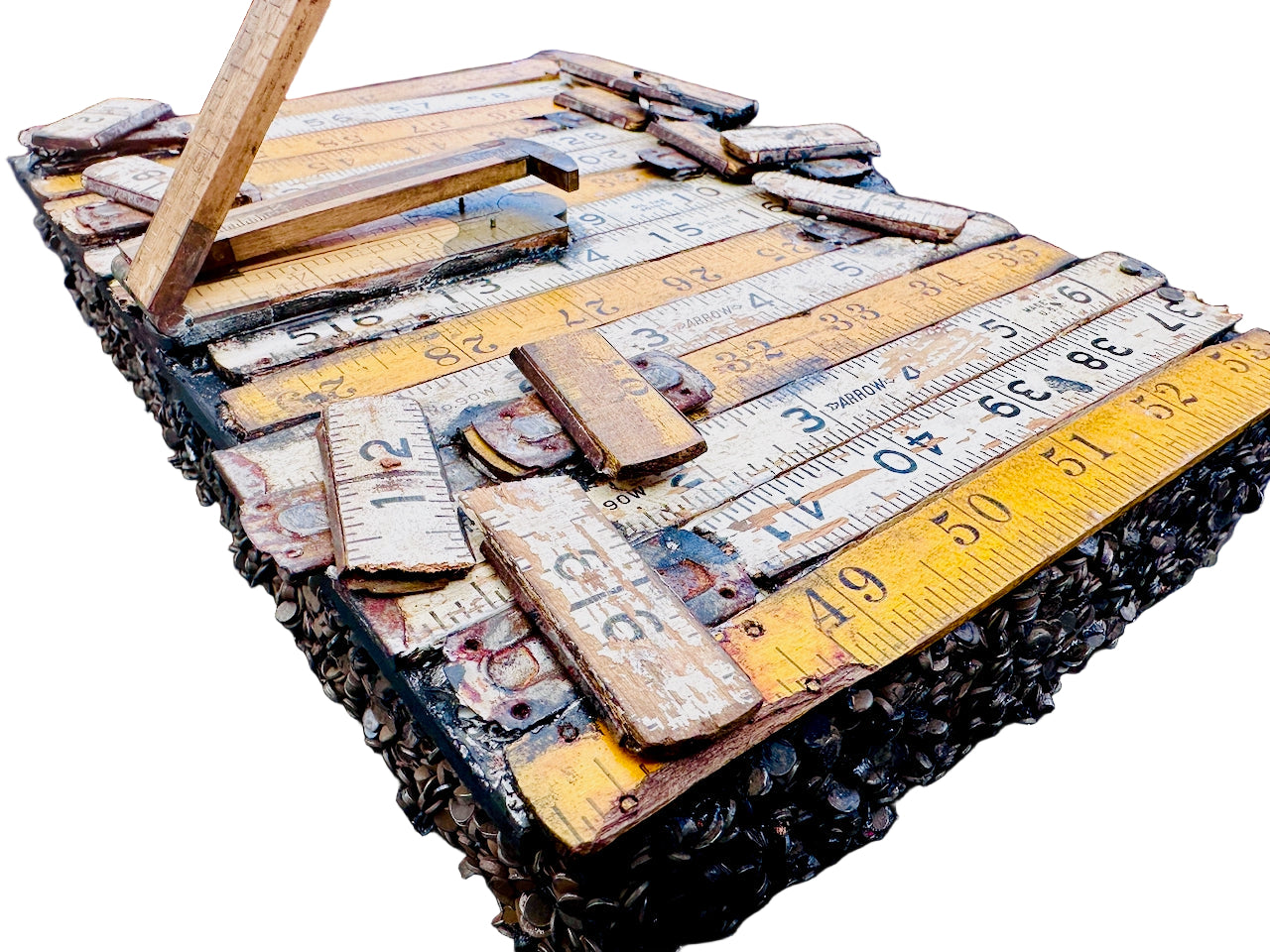 Collection of old wooden rulers and measuring tools on a cigar box