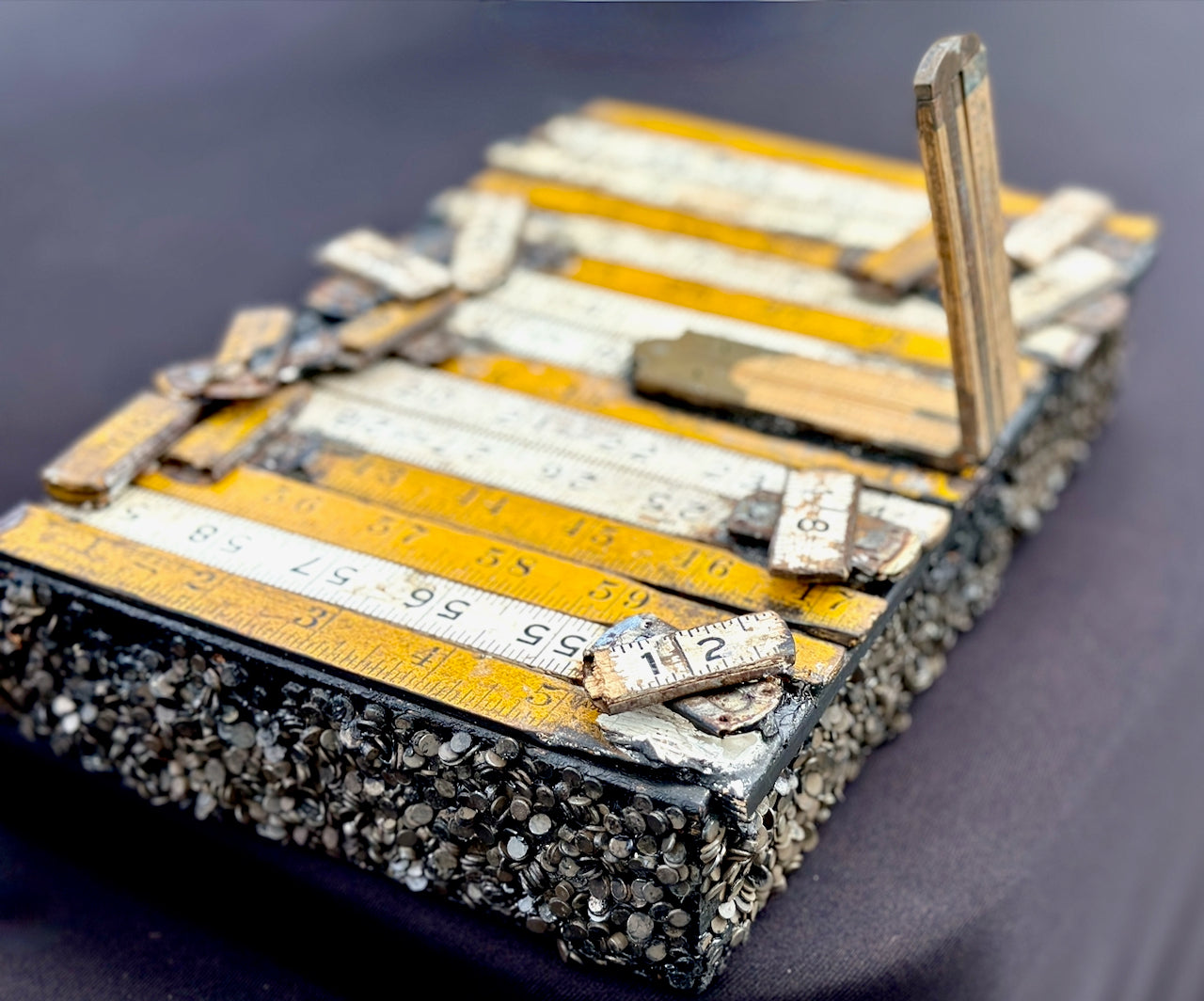 Artistic arrangement of rulers and tools on a textured surface