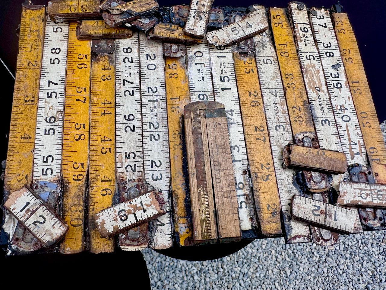 Collection of old, rulers on cigar box