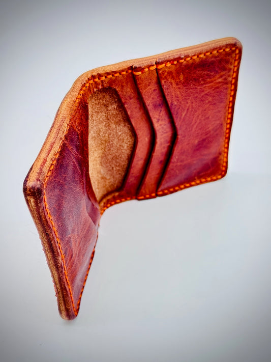 Inside of a cognac Brown leather wallet on a light gray background