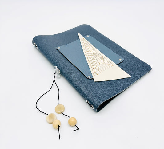 Blue leather refillable journal with geometric design and elastic toggle with beads