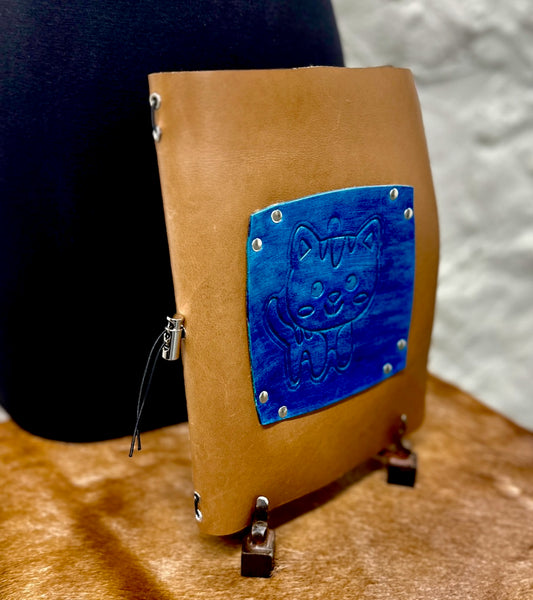 Brown leather journal with a blue embossed leather cat on front cover 