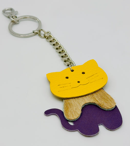 cat key chain and purse fob made from yellow and purple leather and hair on hide tan leather