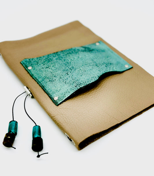 beige and turquoise colored leather journal cover with beaded tassel