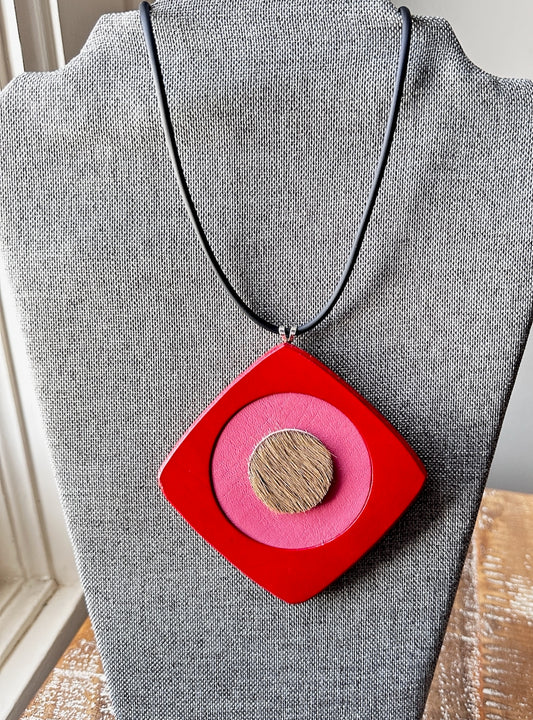 Leather Necklace with a red and pink pendant on a gray mannequin.