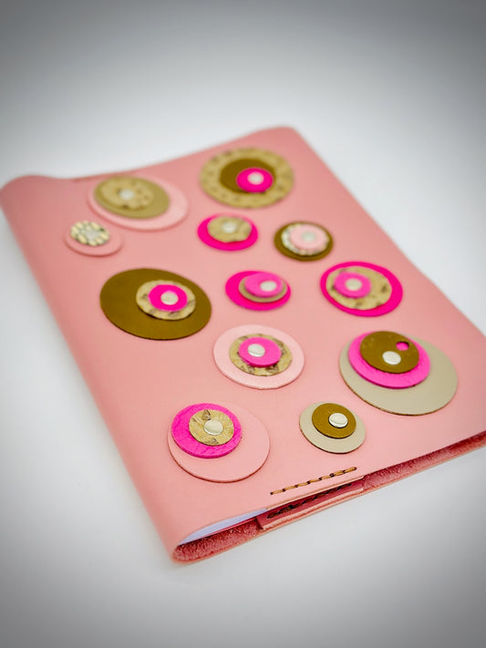 pink, olive and green and tan-refillable-leather-journal-with-circles-front-cover wide shot