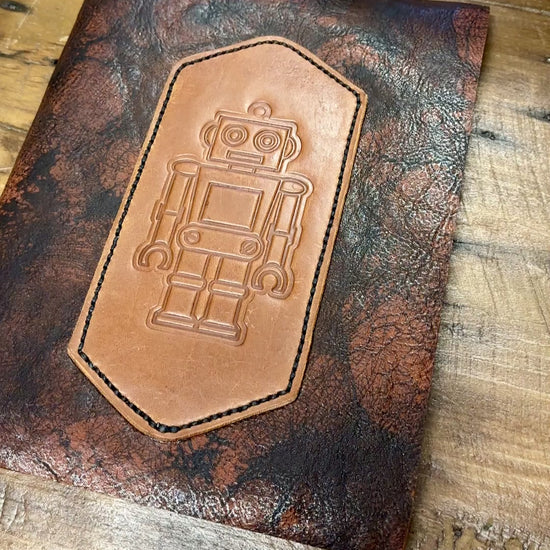 movie flipping open cover of robbie robot leather refillable journal to see blank lined paper notebook insert and back cover