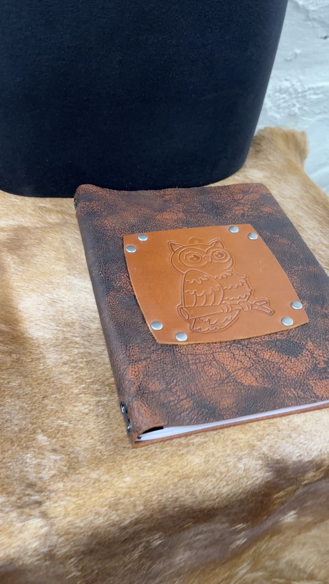 video shows flipping through owl leather journal to see lined blank paper pages