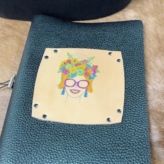 journal cover is opened and we see blank lined journal pages and the front and back covers of the leather journal