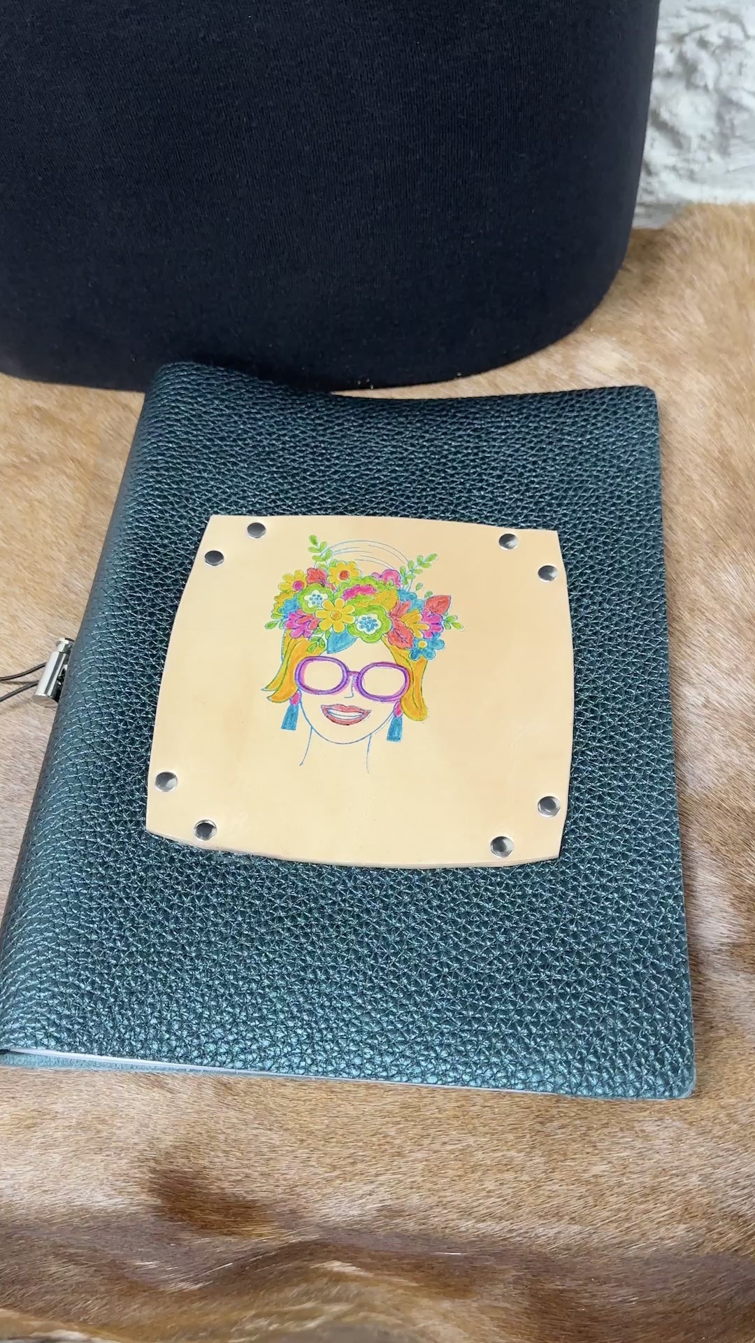 journal cover is opened and we see blank lined journal pages and the front and back covers of the leather journal