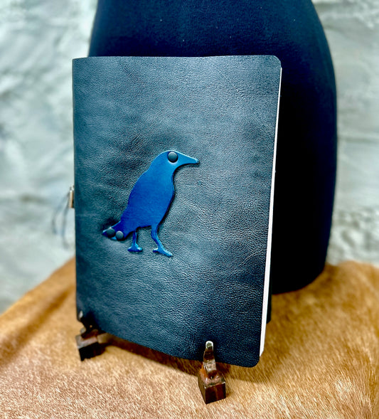 black leather refillable journal with navy leather bird on front cover