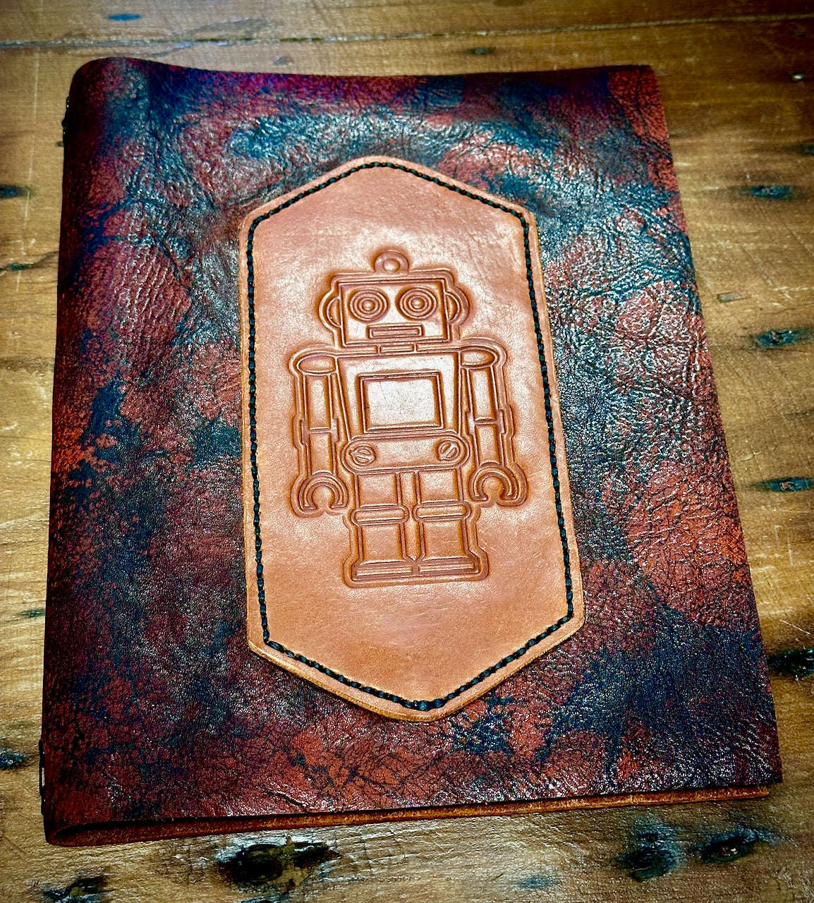 gorgeous brown and black leather refillable journal featuring an embossed image of a robot